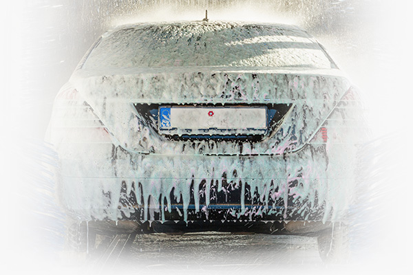Car wash using spray guns.
